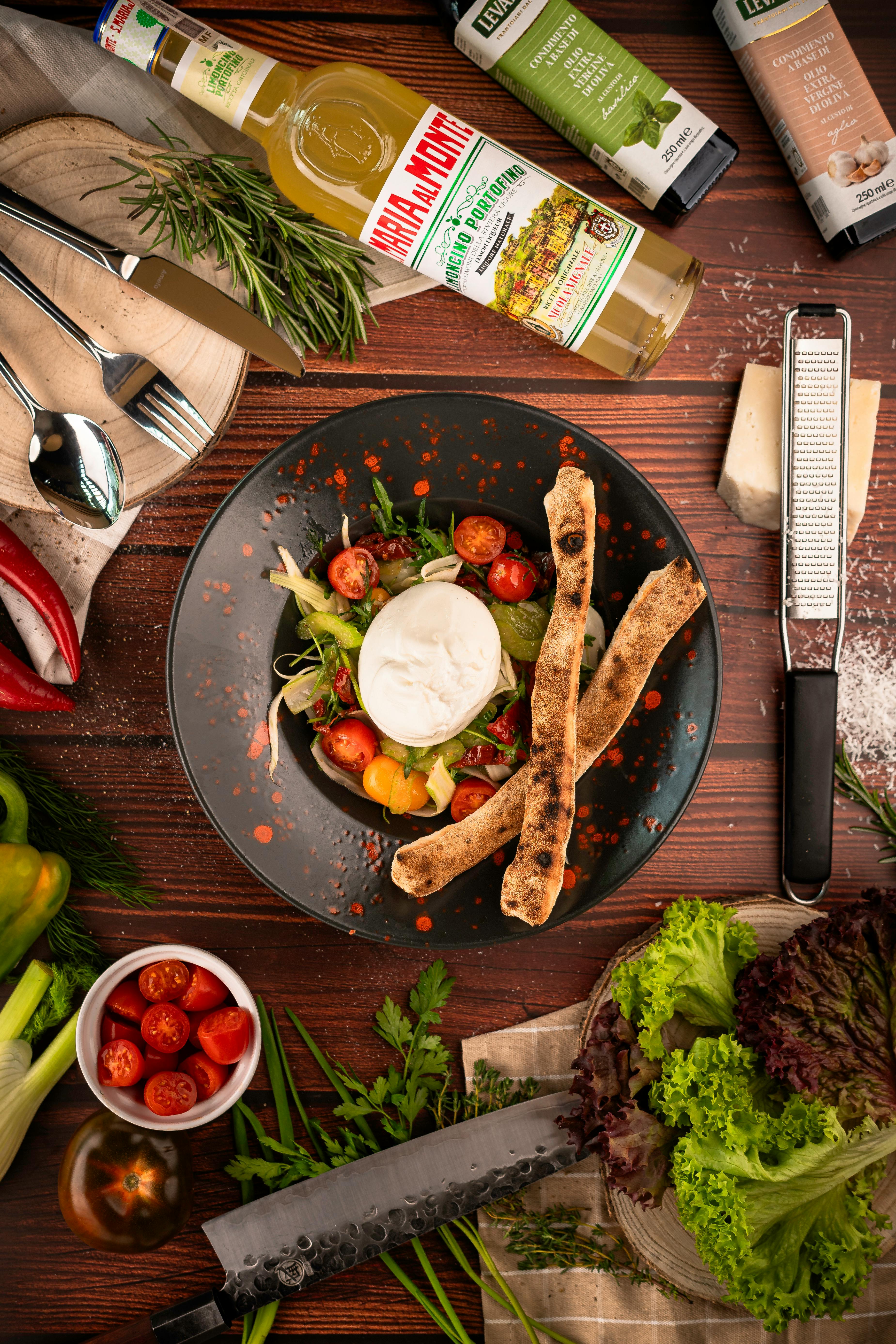 A delectable Italian salad featuring fresh vegetables and gourmet ingredients on a rustic table.